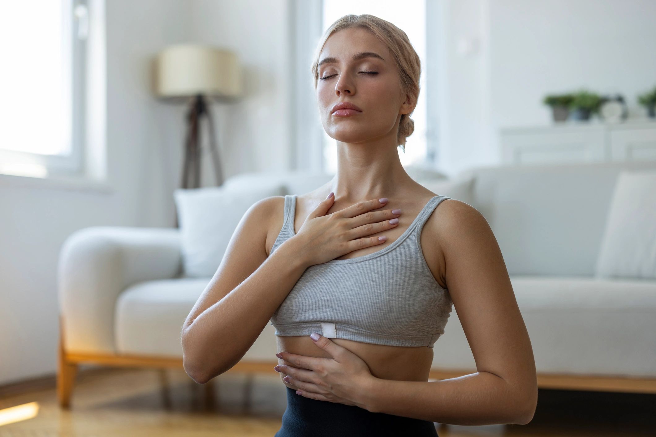 Woman practicing conscious breathing and mindfulness at home