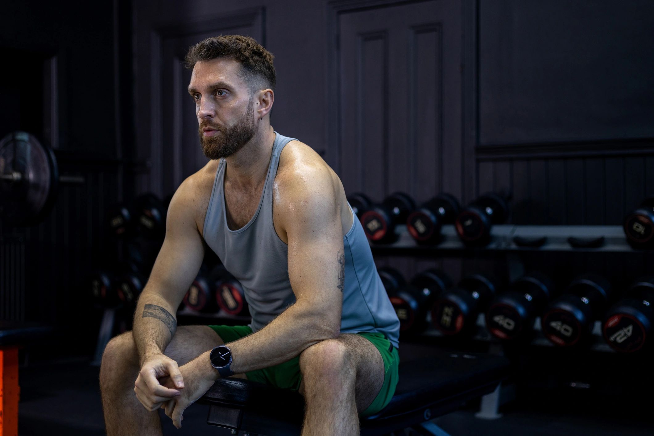 Athlete resting between sets in a gym